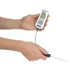 White TempTest 2 Thermometer being held upside down, with penetration probe and digital display.